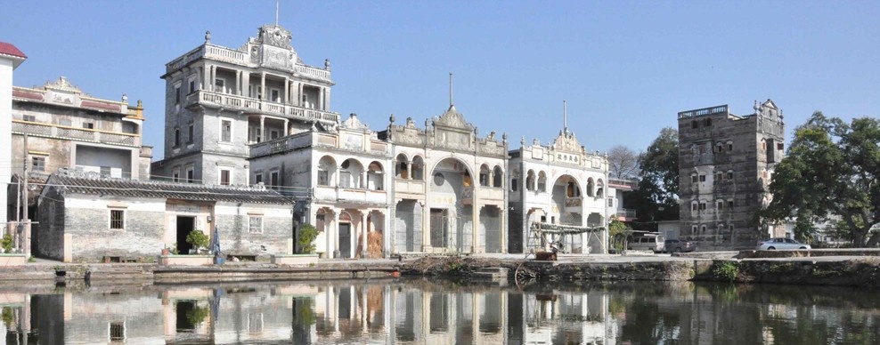 Historic houses and a watchtower in Cangdong Village reflected in the village pond