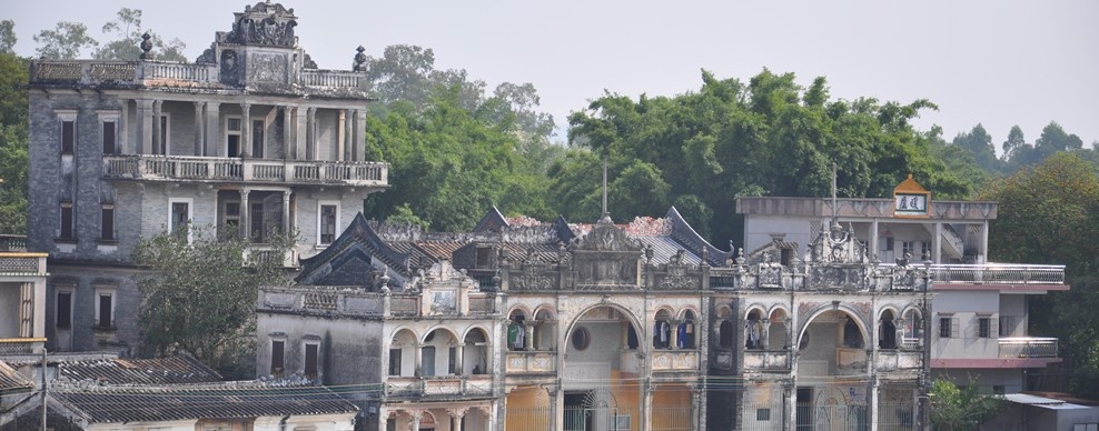 Historic village buildings and diaolou watchtowers among trees in Kaiping