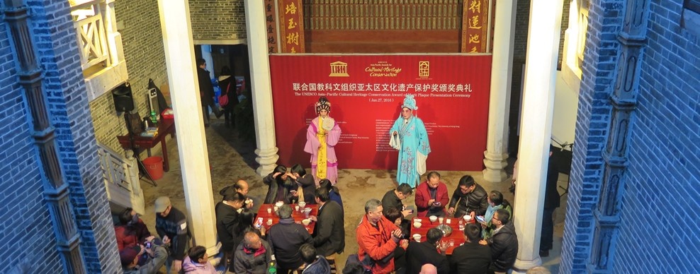 Audience at a performance inside a decorated ancestral hall in Cangdong Village